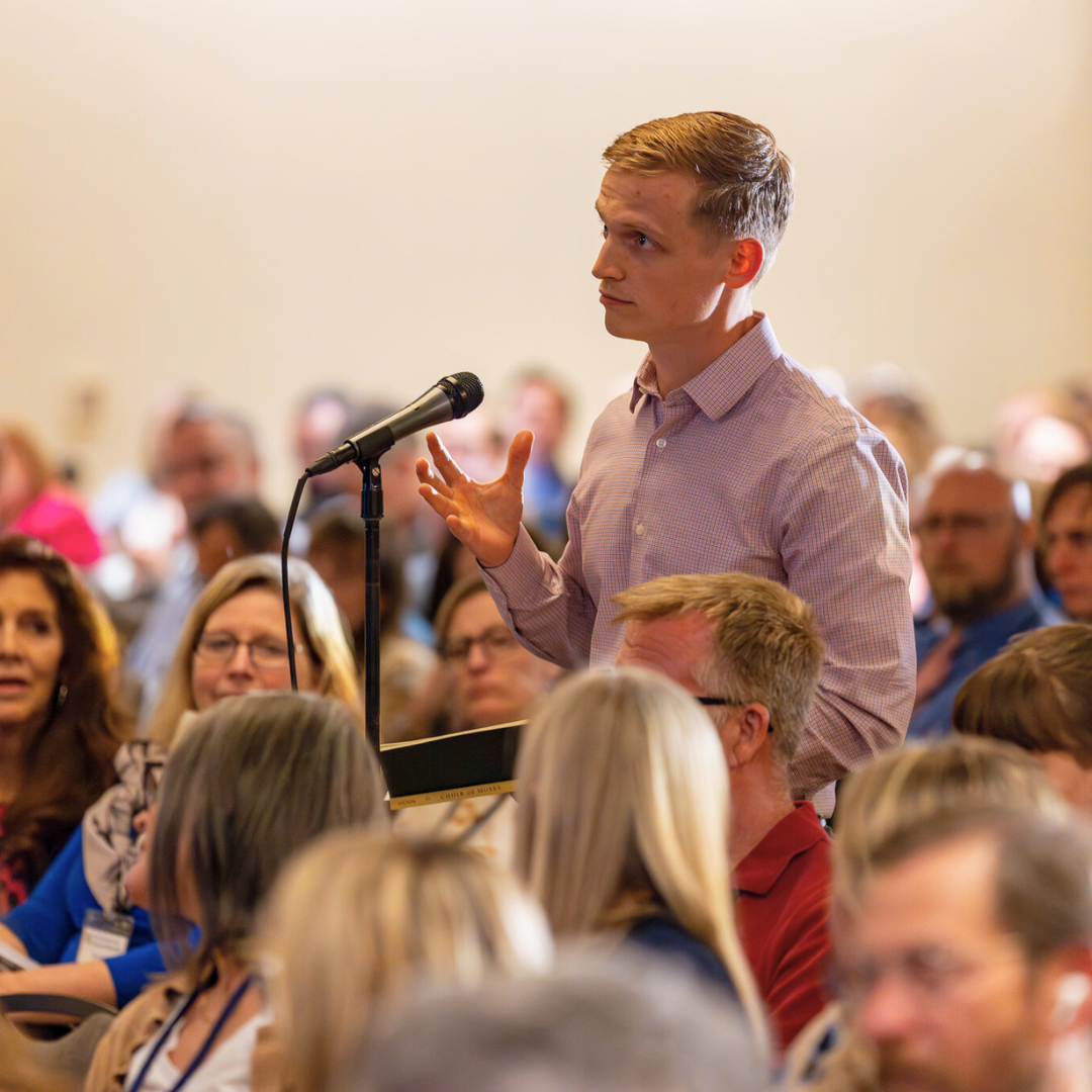 Symposium attendee asking a question from audience