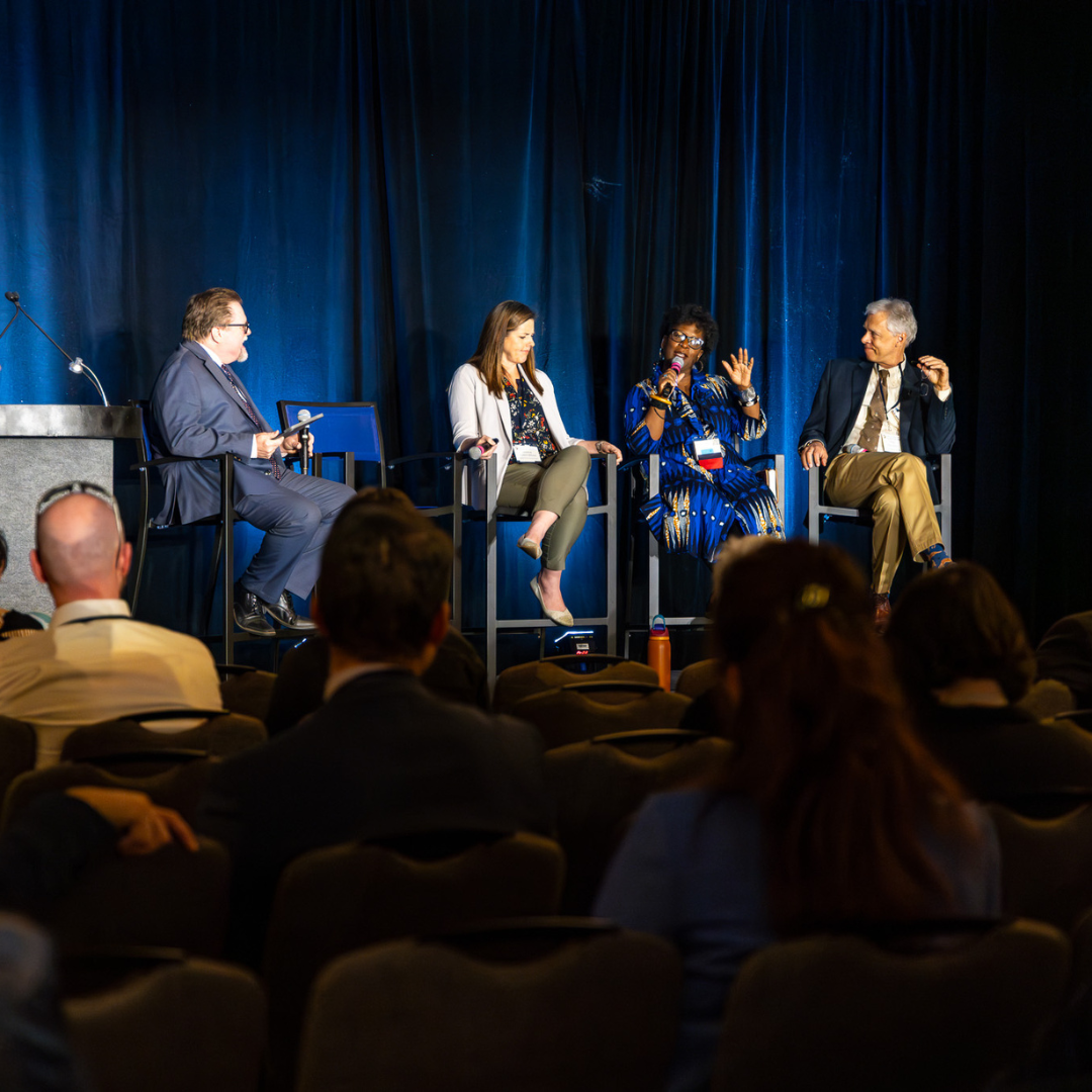 A panel on stage at Symposium